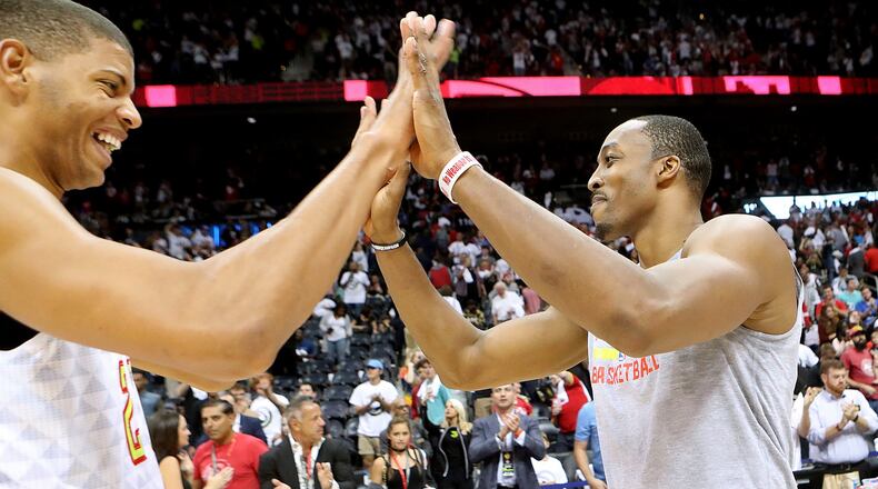 Hawks’ Dwight Howard (left) celebrates a 114-99 victory over the Wizards with Edy Tavares in the home opener of their NBA basketball game at Philips Arena on Thursday, Oct. 27, 2016, in Atlanta. Curtis Compton /ccompton@ajc.com