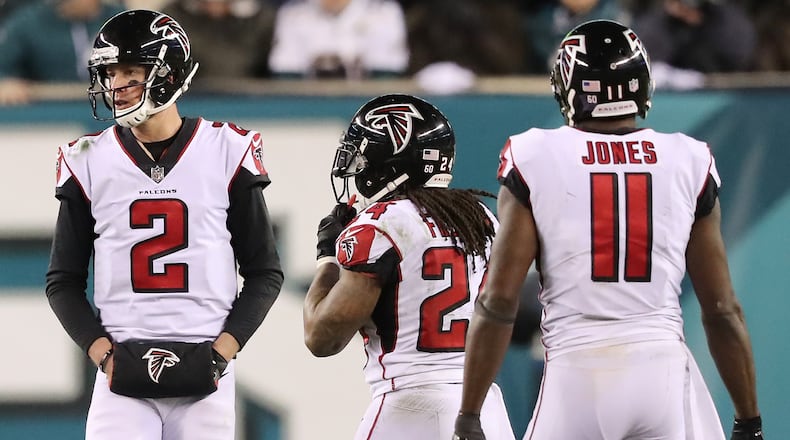 Matt Ryan, Devonta Freeman, and Julio Jones walk off the field after final drive against the Eagles Saturday, Jan. 13, 2018, in Philadelphia.