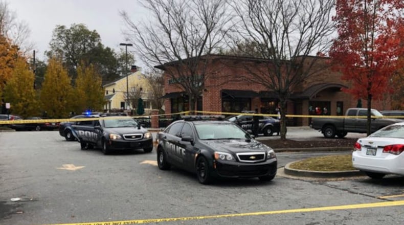 Police investigate the shooting at a DeKalb County shopping center Saturday afternoon.