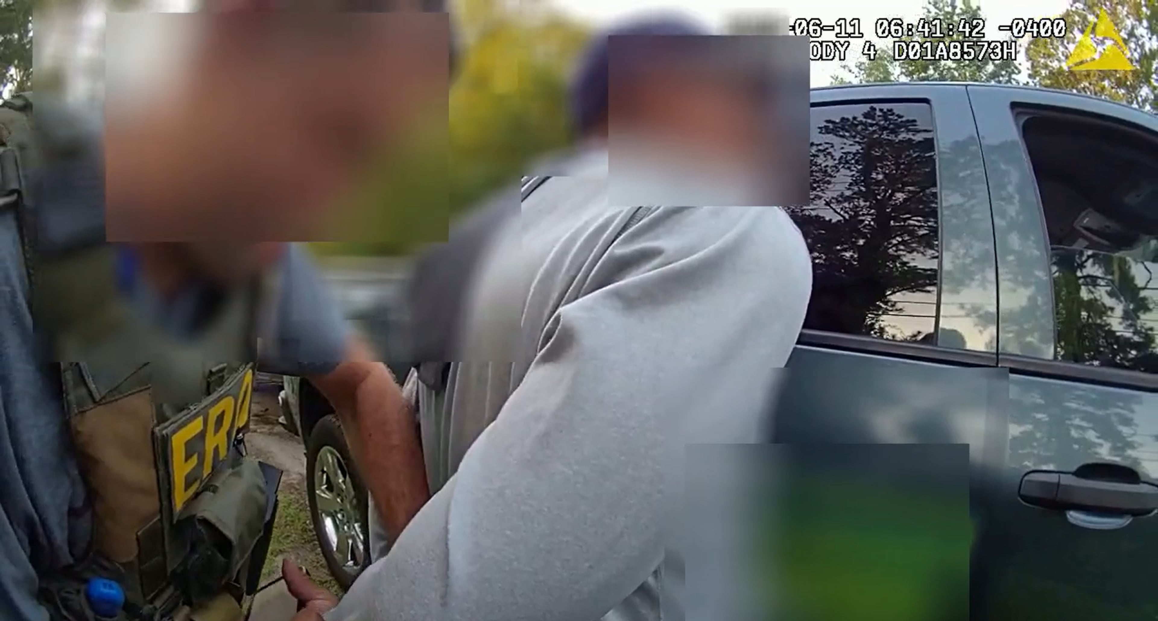 An ICE agent arrests the man riding in the passenger seat of a pickup truck bearing the insignia of a landscaping company. The ICE agent's vest reads ERO, which stands for Enforcement and Removal Operations, the division within ICE that is responsible for enforcing civil immigration laws. (Courtesy of Chatham County Police Department)