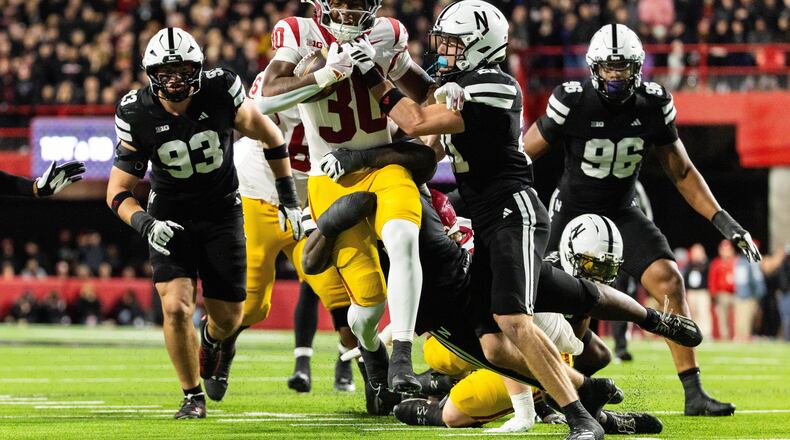 Southern California running back King Miller (30) carries the ball against Nebraska defensive back Rex Guthrie (21) during the second half of an NCAA college football game, Saturday, Nov. 1, 2025, in Lincoln, Neb. (AP Photo/Bonnie Ryan)