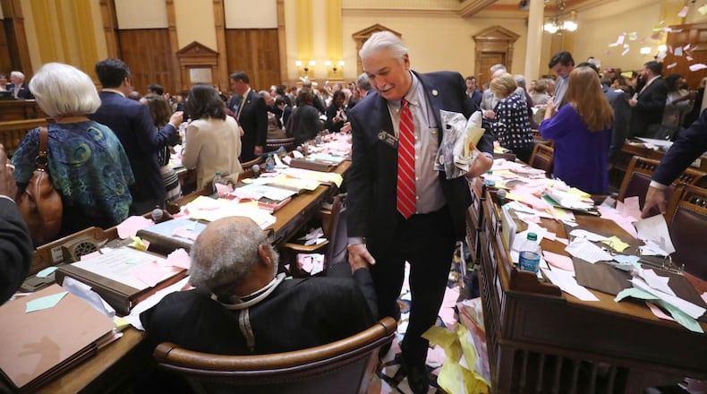 March 29, 2018 - Atlanta, Ga: Sen. Lee Anderson, R-Grovetown, center, leaves his desk as he greets Sen. David Lucas, D-Macon, after Sine Die was proclaimed shortly after midnight during Legislative Day 40 in the Senate Chamber at the Georgia State Capitol Thursday, March 29, 2018, in Atlanta. PHOTO / JASON GETZ