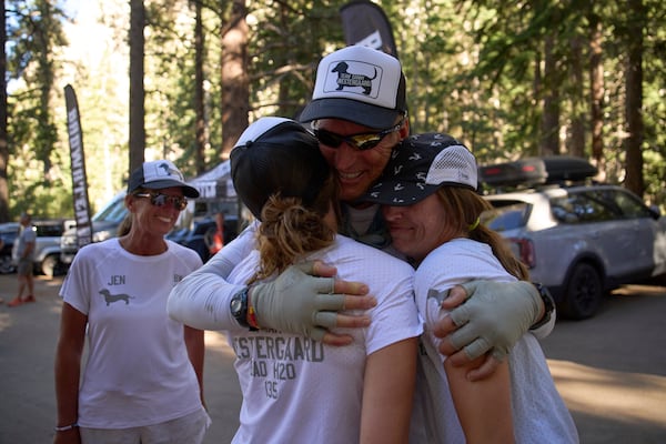 Danny Westergaard, second from right, embraces daughters Meagan Westergaard, right, and Madison Westergaard after finishing the Badwater 135 Ultramarathon, Wednesday, July 9, 2025, at Whitney Portal near Lone Pine, Calif. (AP Photo/John Locher)
