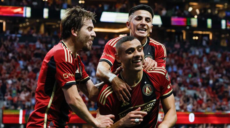 Atlanta United midfielder Thiago Almada (10) and  Saba Lobzhanidze (9) celebrate with Atlanta United forward Giorgos Giakoumakis (7)  after he scored the first goal of his team during the first half against the Chicago Fire at Mercedes-Benz Stadium on Sunday, March 31, 2024.
 Miguel Martinez / miguel.martinezjimenez@ajc.com