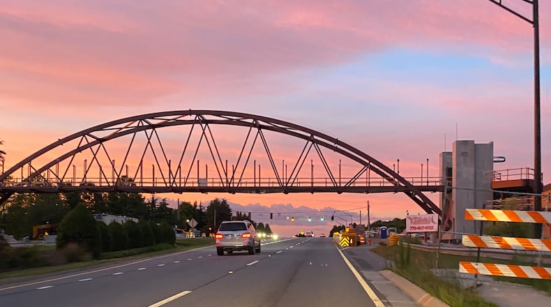 The bridge to connect Peachtree Corners’ Town Center and The Forum shopping center has begun taking shape across Peachtree Parkway. (Photo by Karen Huppertz for the AJC)
