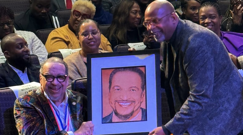 This photo provided by Capital Entertainment, Grammy Award Nominated Gospel Singer Richard Smallwood is handed a portrait of himself during his 75th Birthday Celebration. (Capital Entertainment via AP)