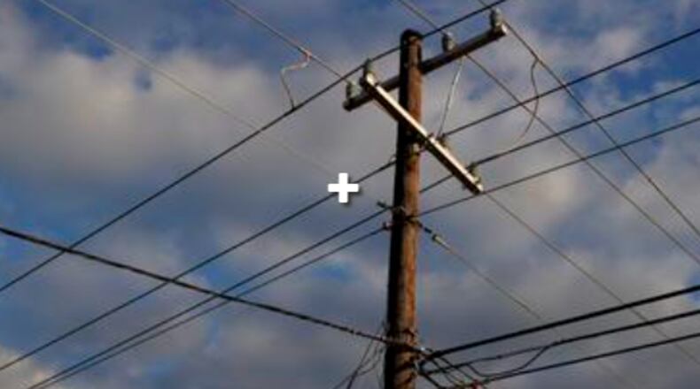 Georgia police officer and three firefighters were injured after being struck by a broken power pole while responding to damage from a thunderstorm, officials said Tuesday. (AJC file photo)