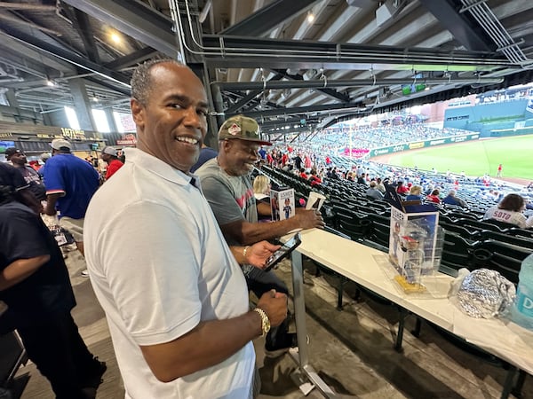 Ray Wilson and Kenley Waller bought $30 tickets each to the Braves game June 18, 2025, only to pick up the bobblehead with no plans to stick around for the game. (Rodney Ho/AJC) 