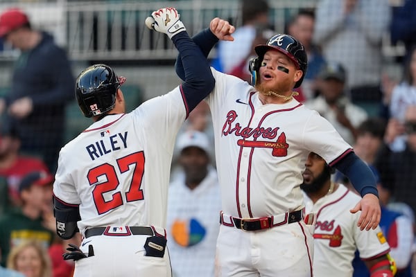 Braves third baseman Austin Riley celebrates his second two-run homer with outfielder Alex Verdugo. (Mike Stewart/AP)