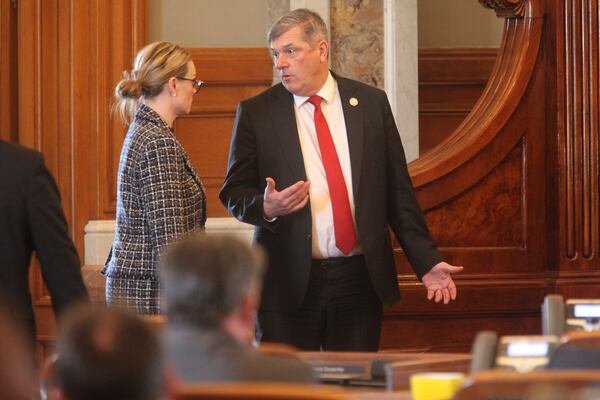 Kansas House Majority Leader Chris Croft, right, R-Overland Park, speaks with Carrie Rahfaldt, left, the House speaker's chief of staff, during a break Friday, April 11, 2025, at the Statehouse in Topeka, Kan. (AP Photo/John Hanna)