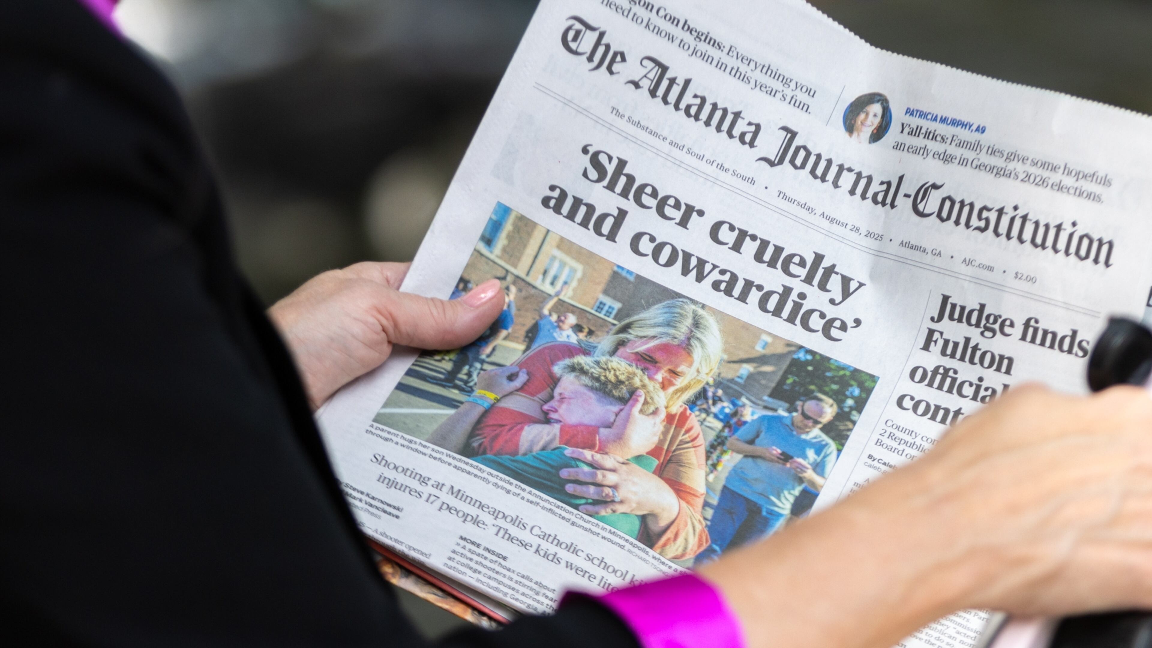 WSB reporter Linda Stouffer interviews people in front of The Atlanta Journal-Constitution building on Thursday, Aug. 28, 2025, in Atlanta. The AJC announced it would cease printing the newspaper at the end of this year. (Arvin Temkar/AJC)
