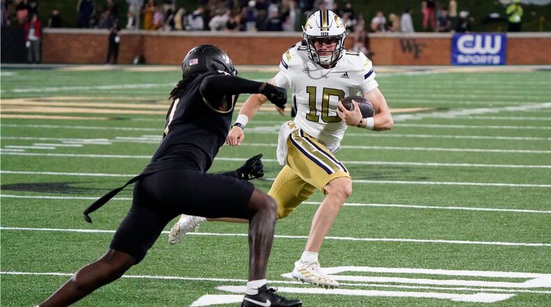 Georgia Tech quarterback Haynes King (10) tries to run past Wake Forest defensive back Caelen Carson (1) during the second half of an NCAA college football game in Winston-Salem, N.C., Saturday, Sept. 23, 2023. (AP Photo/Chuck Burton)