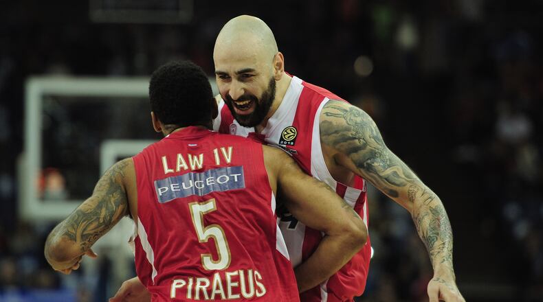 LONDON, ENGLAND - MAY 12: Acie Law and Pero Antic of Olympiacos Piraeus celebrate victory during the Turkish Airlines EuroLeague Final Four final between Olympiacos Piraeus and Real Madrid at the O2 Arena on May 12, 2013 in London, England. (Photo by Jamie McDonald/Getty Images)