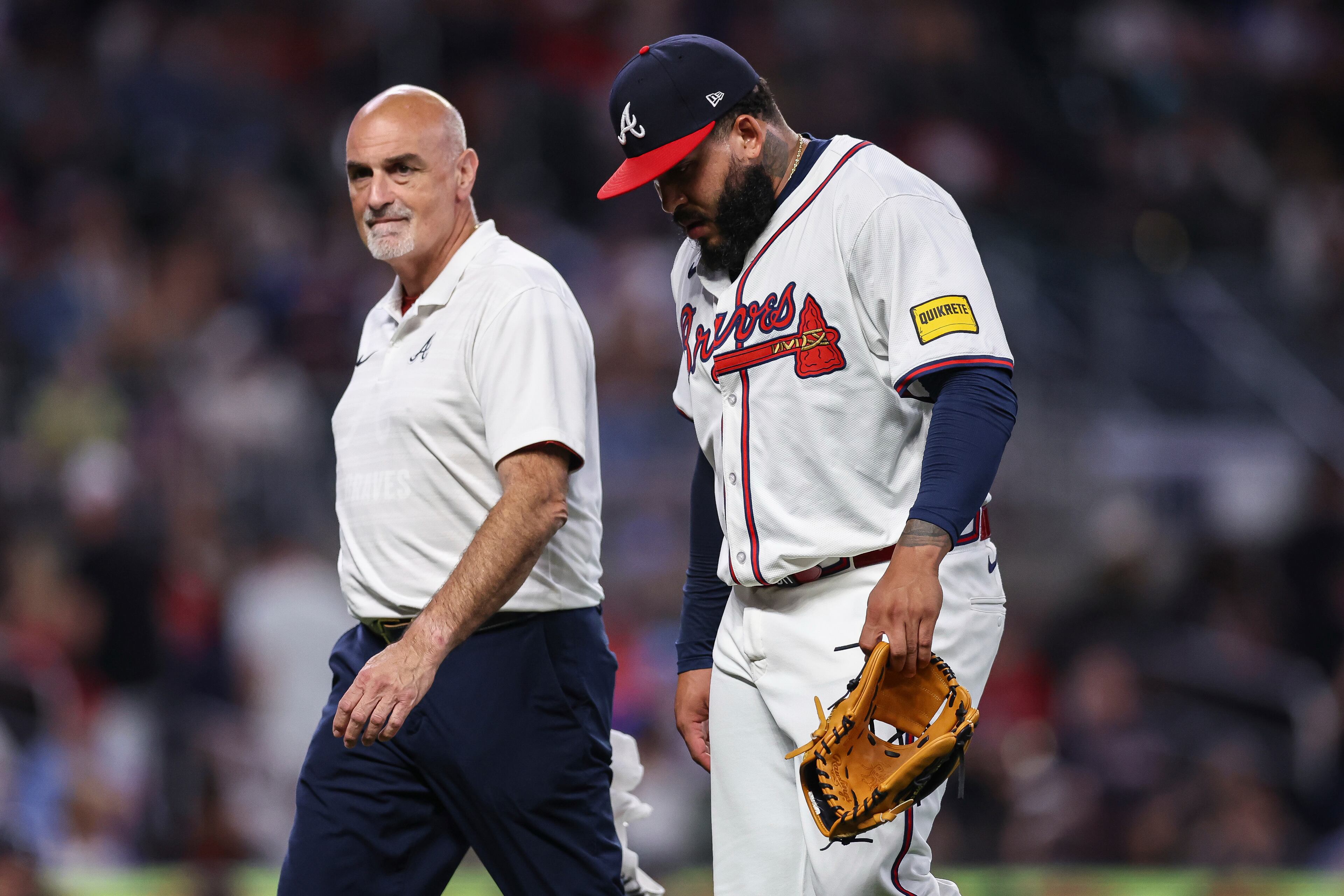 Atlanta Braves pitcher Daysbel Hernández, right, exits the game after suffering an injury in the eighth inning of a baseball game against the Arizona Diamondbacks, Wednesday, June 4, 2025, in Atlanta. (AP Photo/Colin Hubbard)