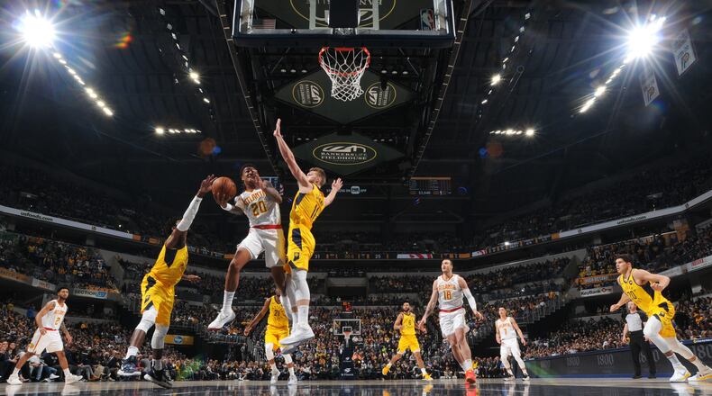 John Collins of the Atlanta Hawks goes to the basket against the Indiana Pacers on December 31, 2018 at Bankers Life Fieldhouse in Indianapolis, Indiana.