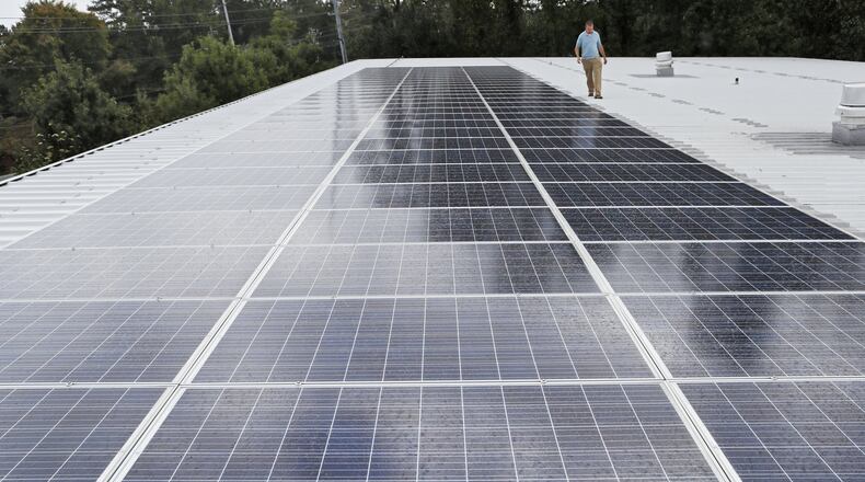 Scott Starowicz, SAE’s chief financial officer, walks past the school’s solar panel array. The pre-K-8 school in Mableton is believed to be the first elementary school in the state with plans to be powered 100% by solar energy. Sustainability efforts are integrated into the school’s curriculum. BOB ANDRES / ROBERT.ANDRES@AJC.COM