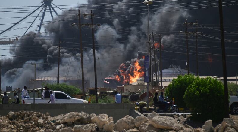 FILE - Smoke billows after drone strikes by the paramilitary Rapid Support Forces (RSF) targeted the northern port in the Red Sea city of Port Sudan, Sudan, Tuesday, May 6, 2025. (AP Photo/File)
