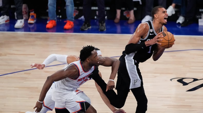 San Antonio Spurs forward Victor Wembanyama, right, drives as New York Knicks forward Og Anunoby, left, defends during the second half of Game 4 of the NBA Finals basketball series, Wednesday, June 10, 2026, in New York. (AP Photo/Ross D. Franklin)