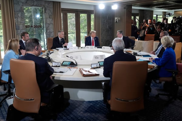 Italy's Prime Minister Giorgia Meloni, from left, France's President Emmanuel Macron, Canada's Prime Minister Mark Carney, President Donald Trump, Britain's Prime Minister Keir Starmer and Germany's Chancellor Friedrich Merz participate in a session of the G7 Summit, Monday, June 16, 2025, in Kananaskis, Canada. (AP Photo/Mark Schiefelbein)