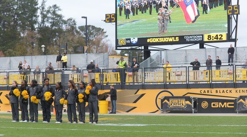 Some of the Kennesaw State University cheerleaders link arms in the north end zone of KSU’s Fifth Third Bank Stadium during the national anthem prior to the start of the football game Saturday, Nov. 11, 2017. This marked the cheerleaders’ return to the field in the wake of some taking a knee during the national anthem in previous games. Photo: Daniel Varnado / Special to the AJC