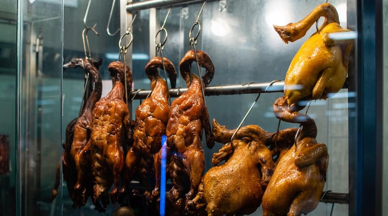 Barbecued poultry hangs right at the counter at BBQ Corner in Jusgo Food Court in Duluth. CONTRIBUTED BY HENRI HOLLIS