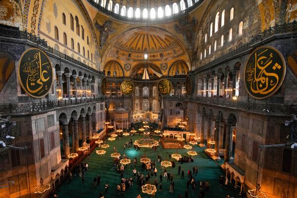People visit Byzantine-era Hagia Sophia mosque, in Istanbul, Turkey, Sunday, April 13, 2025. (AP Photo/Emrah Gurel)