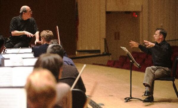 Sitting onstage for consultation, Atlanta composer Richard Prior (right) talks with Atlanta Symphony Orchestra music director Robert Spano amid the first rehearsal of Prior’s Symphony No. 3 in Symphony Hall on Tuesday. Prior considers it a career highlight, having a full symphonic work performed by an orchestra at the level of the ASO. PHIL SKINNER / SPECIAL