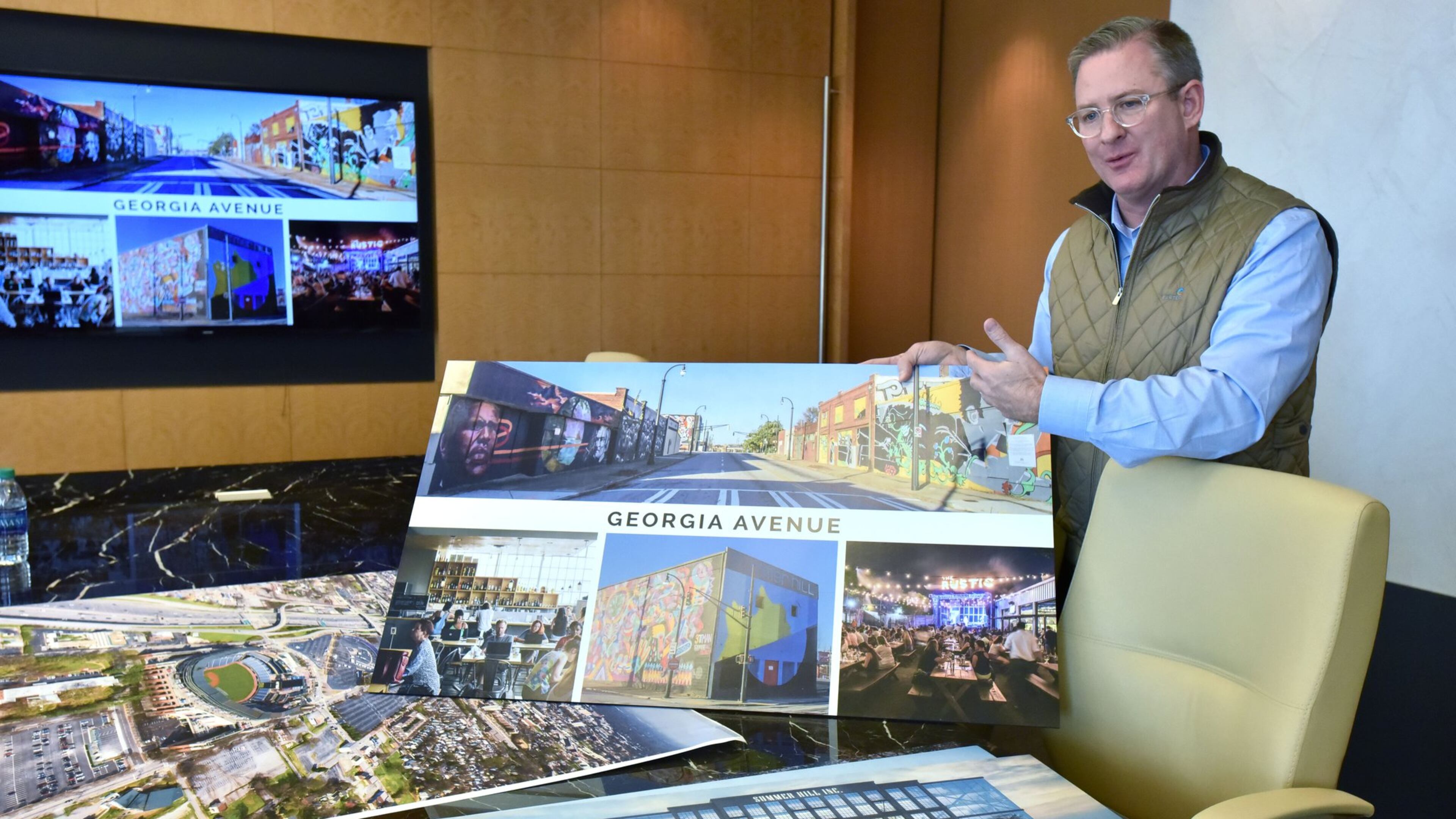 Scott Taylor, CEO of the Atlanta real estate development firm Carter, shows off renderings for the planned redevelopment of the Turner Field area in January 2017. Georgia State University and a private development team led by Carter acquired the former Atlanta Braves stadium near downtown that month. (Hyosub Shin/AJC)