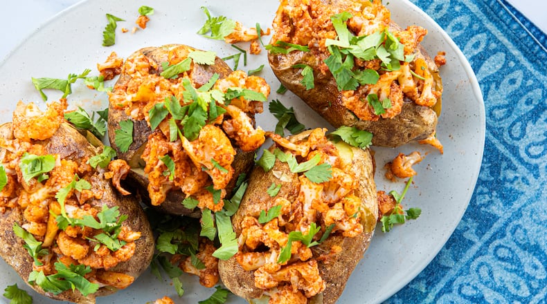 Aloo Gobi-Style Baked Potatoes. (Aaliyah Man for The Atlanta Journal-Constitution / Food styling by Kate Williams)