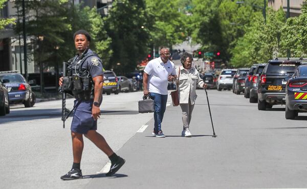 KJ Johnson (center), a U.S. Air Force veteran, helped a woman named Doris (right) down nine flights of stairs to safety after the shooting Wednesday at Northside Hospital Midtown medical center.