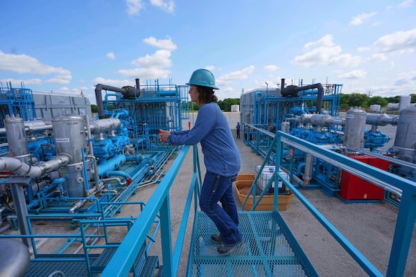BKV Carbon Ventures senior facility engineer Laura Mamazza stands near part of a compression station at a carbon capture and sequestration facility in Bridgeport, Texas, Thursday, May 29, 2025. (AP Photo/LM Otero)