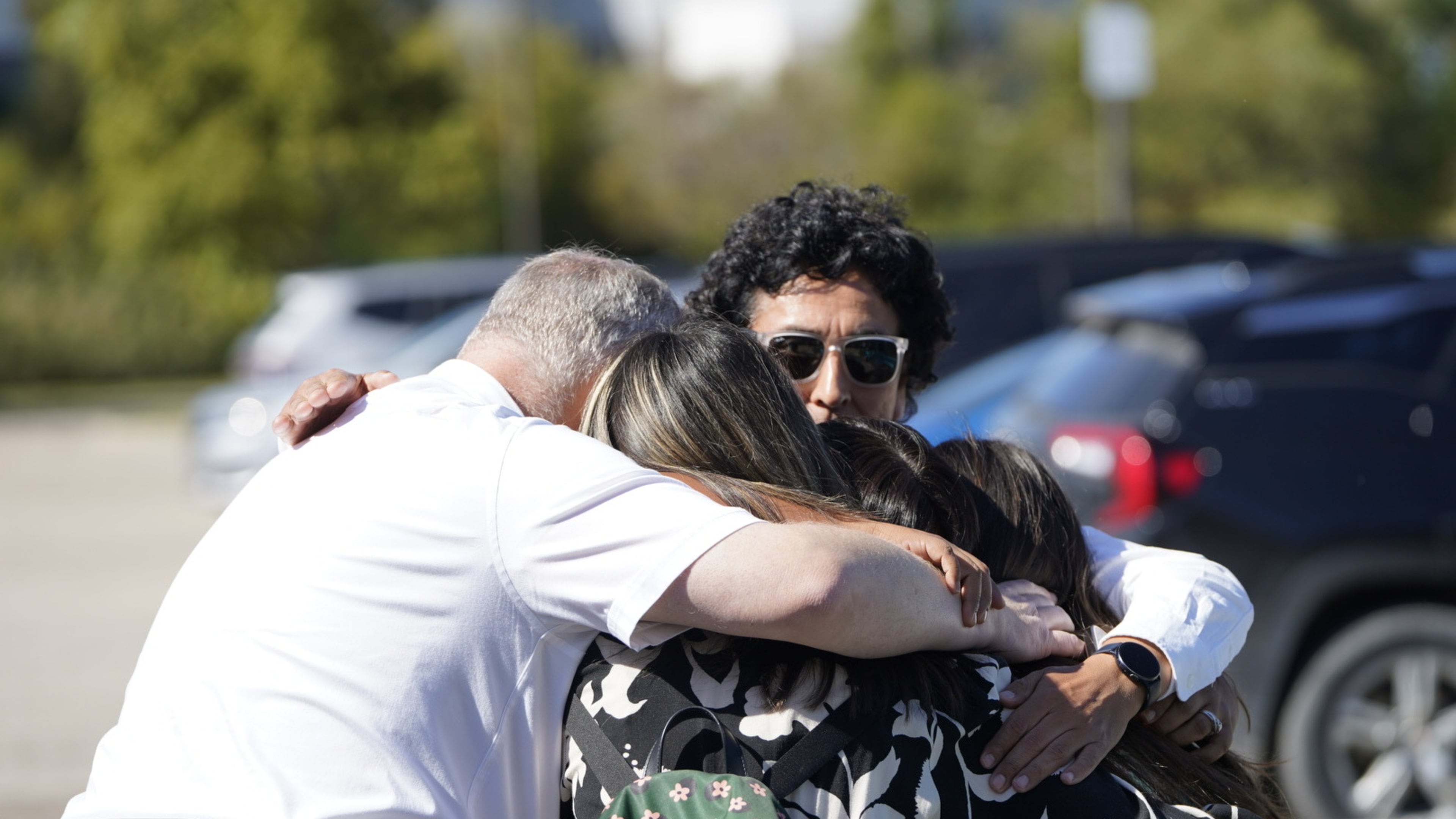 People meet at a reunification area at the Trillium Theater after an active shooter incident and fire at The Church of Jesus Christ of Latter-day Saints in Grand Blanc, Mich on Sunday, Sept. 28, 2025. (Lukas Katilius/The Flint Journal via AP)