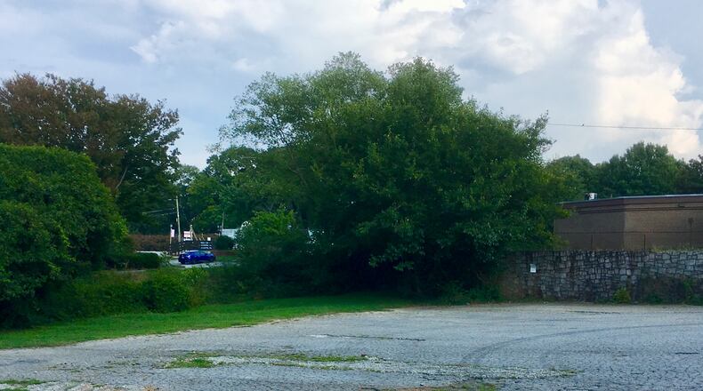A portion of the four acres owned by Avondale Estate and likely the area cited for improvements in a proposed development agreement between the city and Trammell Crow Residential. In the background right is the abandned Peachtree Credit Union bank, and to the left is the Art Lot. Bill Banks for the AJC