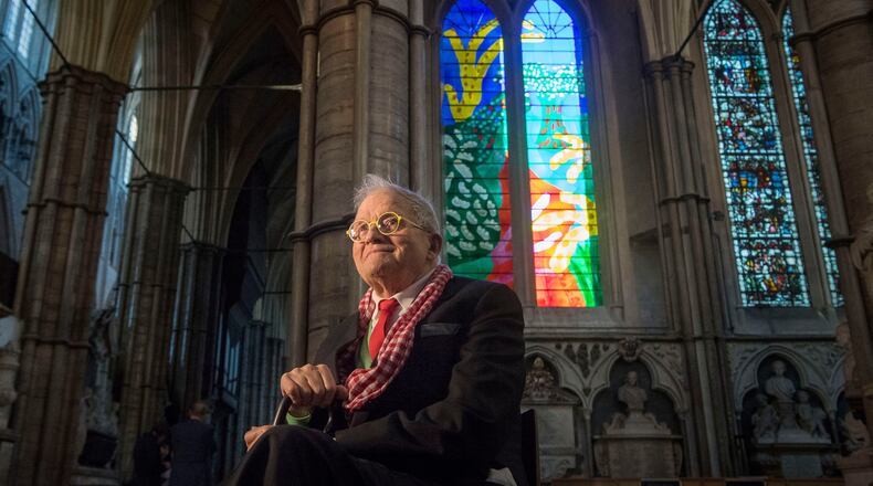 FILE - British artist David Hockney sits in front of The Queen's Window, a new stained glass window at Westminster Abbey, London, designed by David Hockney and revealed for the first time on Wednesday Sept. 26, 2018. (Victoria Jones/Pool via AP, File)