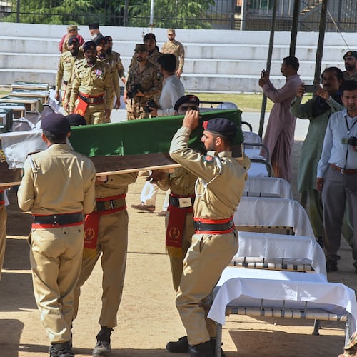 Army soldiers carry a flag-wrapped casket of military personnel, killed in the Wednesday's helicopter crashed, during a funeral prayer, in Muzaffarabad, the capital of Pakistan-administered Kashmir, Thursday, June 11, 2026. (AP Photo/M.D. Mughal)