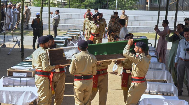 Army soldiers carry a flag-wrapped casket of military personnel, killed in the Wednesday's helicopter crashed, during a funeral prayer, in Muzaffarabad, the capital of Pakistan-administered Kashmir, Thursday, June 11, 2026. (AP Photo/M.D. Mughal)