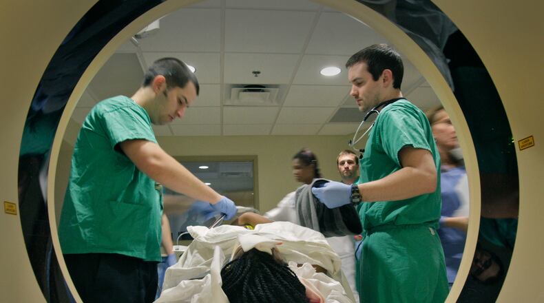 John Dugan, RT (left) and Dr. John Dooley prepare a motor vehicle crash victim for a CT scan at Atlanta Medical Center on March 10, 2011. Bob Andres bandres@ajc.com