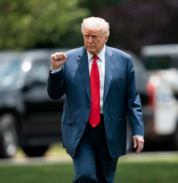 
                        President Donald Trump gestures after taking a photo with construction workers at the site of a new flagpole on the South Lawn of the White House in Washington, June 9, 2025. A federal appeals court agreed on Tuesday, June 10, 2025, to allow President Trump to maintain many of his tariffs on China and other U.S. trading partners, extending a pause it granted shortly after another panel of judges ruled in late May that the import taxes were illegal. (Doug Mills/The New York Times)
                      