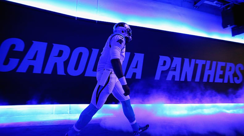 Cam Newton  walks to the field in the glow of blue lights prior to the NFC Championship Game in Charlotte, N.C. (Photo by Streeter Lecka/Getty Images)