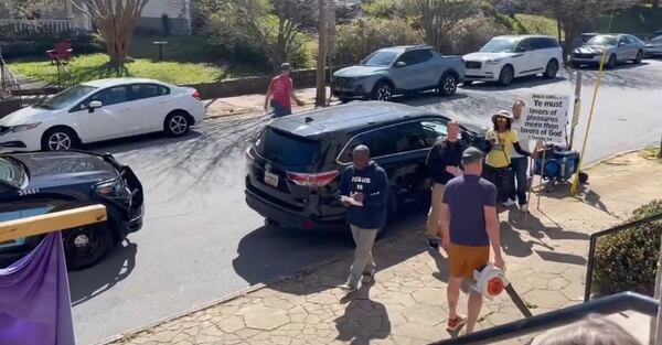 John McVay, a neighbor of St. Paul United Methodist Church, tries to drown own protestors with a leaf blower
