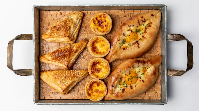 Juniper Cafe offers an international selection of sweet and savory baked goods, including, from left, spinach and cheese turnovers, Portuguese egg tarts and Turkish egg bread. Photo by Eric Sun