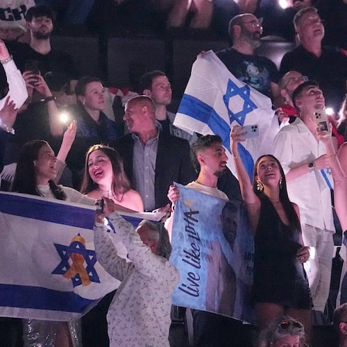 FILE - Israeli fans cheer for Yuval Raphael from Israel after performing during the Semi-Final of the 69th Eurovision Song Contest, in Basel, Switzerland, Thursday, May 15, 2025. (AP Photo/Martin Meissner, File)