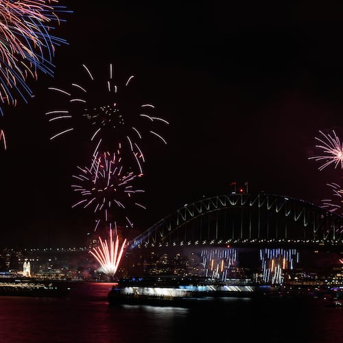 Fireworks burst over the Sydney Harbour Bridge as New Year's celebrations begin in Sydney, Wednesday, Dec. 31, 2025. (AP Photo/Rick Rycroft)