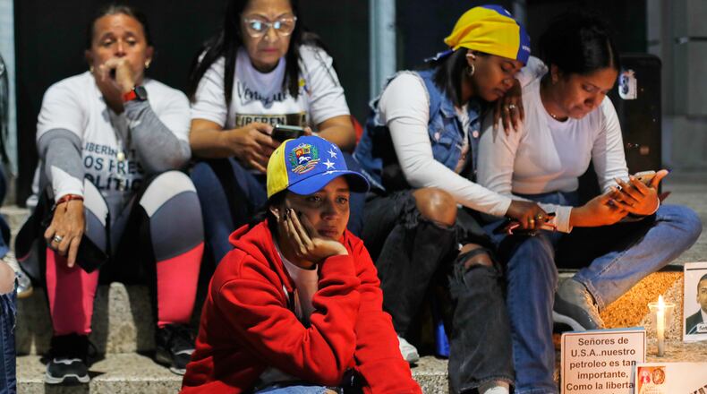 Relatives of detainees they say are held for political reasons wait outside El Helicoide, the headquarters of Venezuela's intelligence service and a detention center, after the National Assembly approved an amnesty bill in Caracas, Venezuela, Thursday, Feb. 19, 2026. (AP Photo/Crisitian Hernandez)