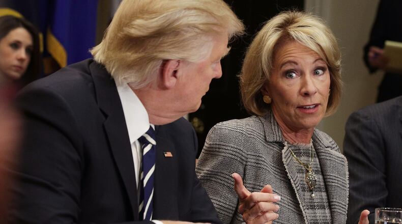 U.S. Secretary of Education Betsy DeVos and President Donald Trump at a parent-teacher conference listening session at the White House in February. (Photo by Alex Wong/Getty Images)