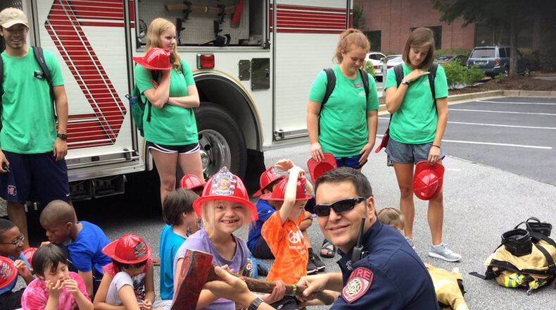 Children from Camp Happy Hearts visit the Alpharetta Fire Department. ADPS FIRE MARSHAL