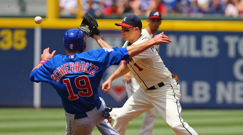 The Cubs' Nate Schierholtz is out attempting to steal second as Braves Tyler Pastornicky awaits the throw during the second inning of their MLB game on Sunday, May 11, 2014, in Atlanta. CURTIS COMPTON / CCOMPTON@AJC.COM