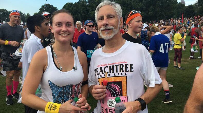 Sarah Stokes and her father, Dwain Cassady, run the 50th AJC Peachtree Road Race on Thursday, their 20th together and Cassady’s 36th.