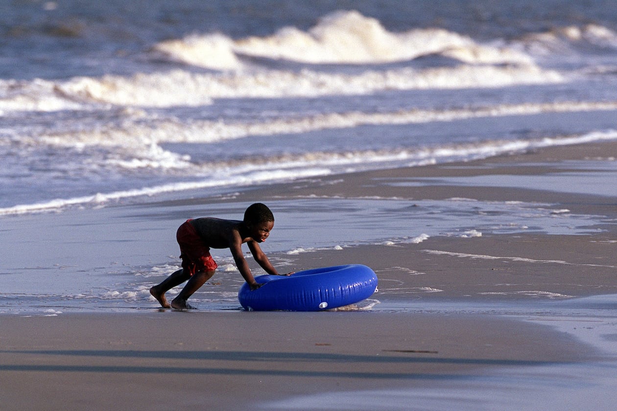 A boy plays in the surf in the Atlantic on Jekyll Island. (Louie Favorite/AJC 2001)