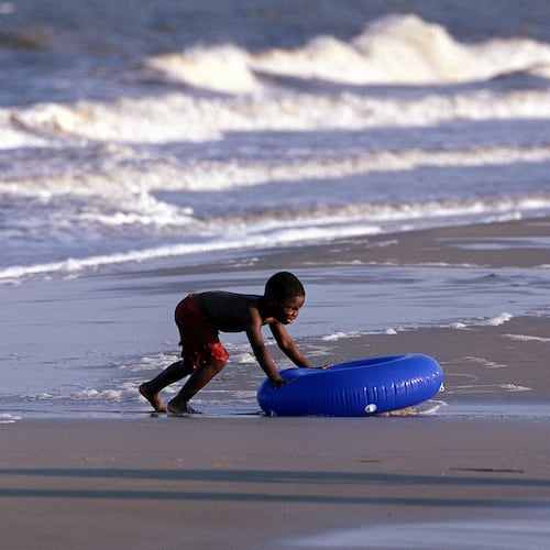 A boy plays in the surf in the Atlantic on Jekyll Island. (Louie Favorite/AJC 2001)
